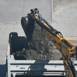 Excavator dumping dirt into a truck